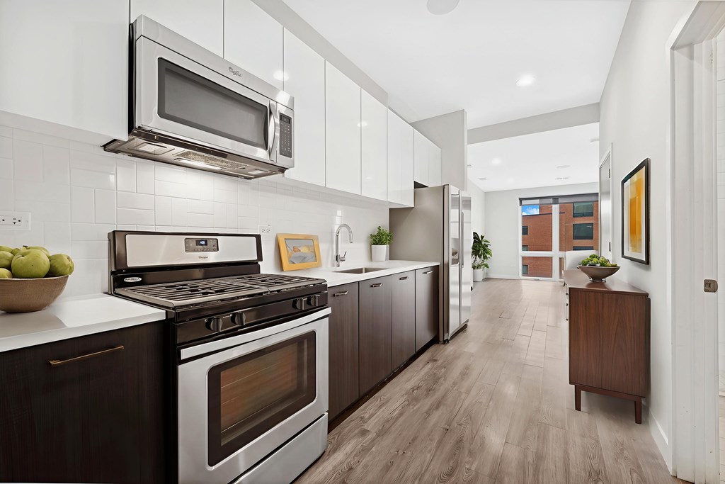 Modern kitchen at Highpoint Buena Park on Broadway with quartz countertops, stainless steel appliances, and sleek cabinetry in a luxury Buena Park apartment near Lake Michigan in Chicago