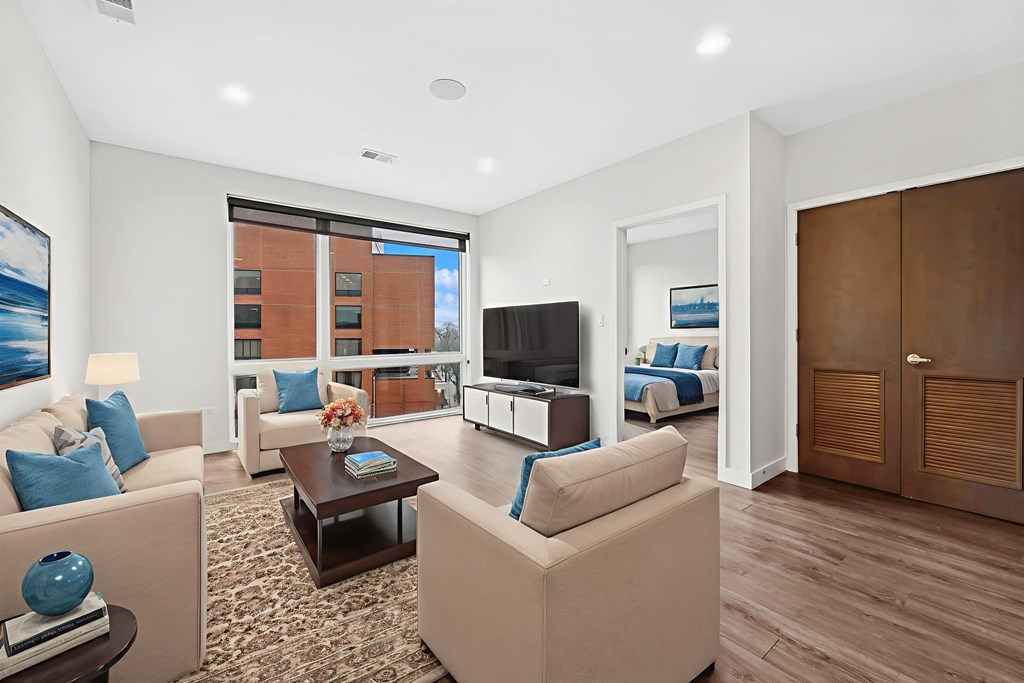 Open concept living room at Highpoint Buena Park on Broadway featuring large windows, abundant natural light, and modern finishes in a luxury Buena Park apartment near Chicago’s lakefront trail