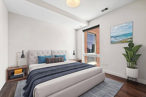 A bedroom with a large bed and a painting on the wall.