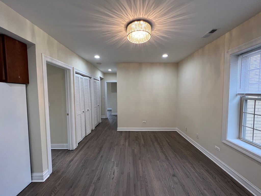 a living room with white walls and wood floors at Christiana 4954, Chicago Illinois