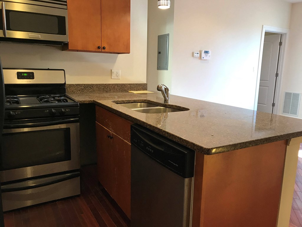 a kitchen with granite counter top and stainless steel appliances at Tripp 4321, Chicago, 60641