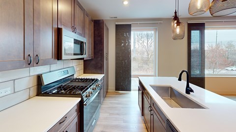 A kitchen with a stove top oven and a microwave above it.