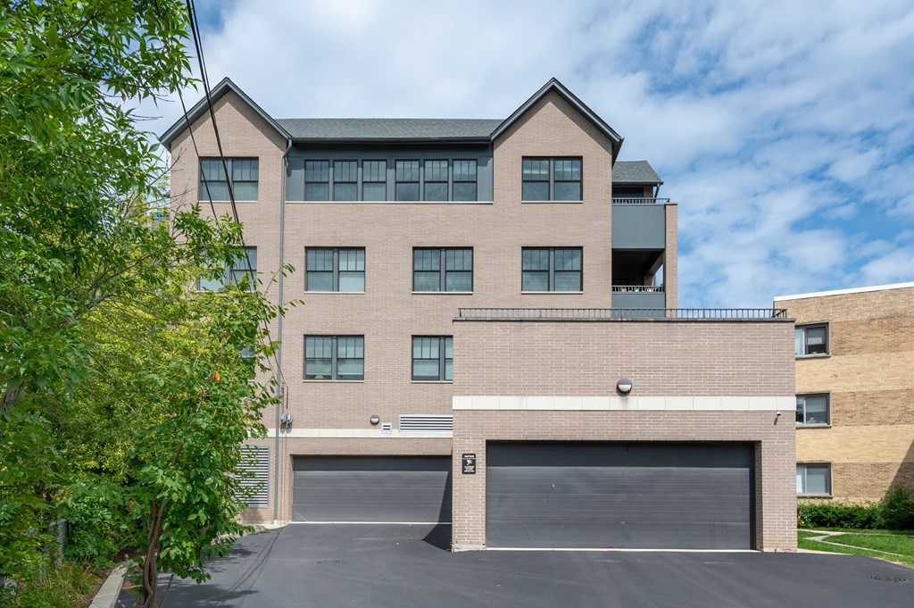 A large two-story building with a garage door in front.