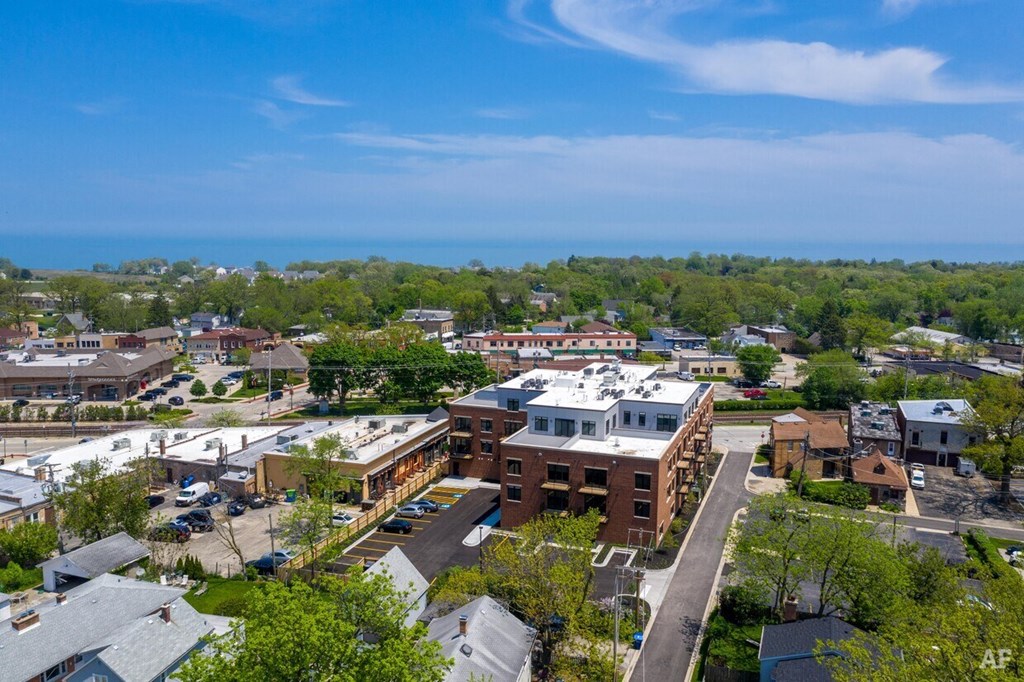 an aerial view of a city with buildings and the ocean in the background  the floor plan of the residence
