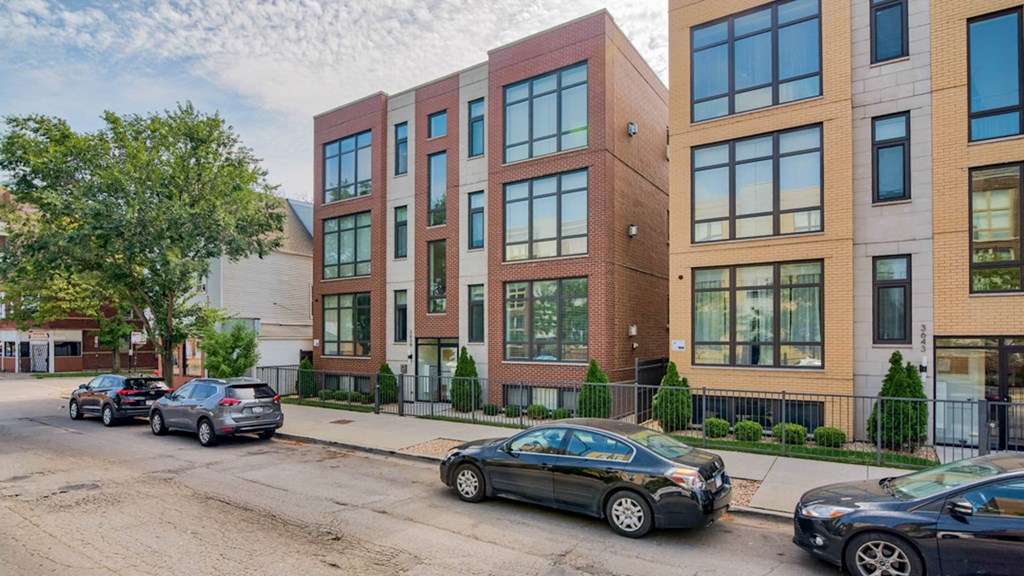 an apartment building on a city street with cars parked at Montrose 3634, Chicago, IL