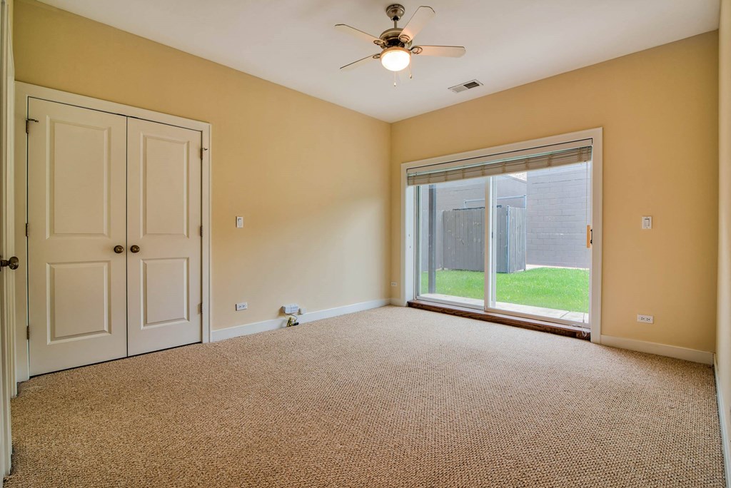 an empty living room with a large window and a ceiling fan at Montrose 3634, Chicago