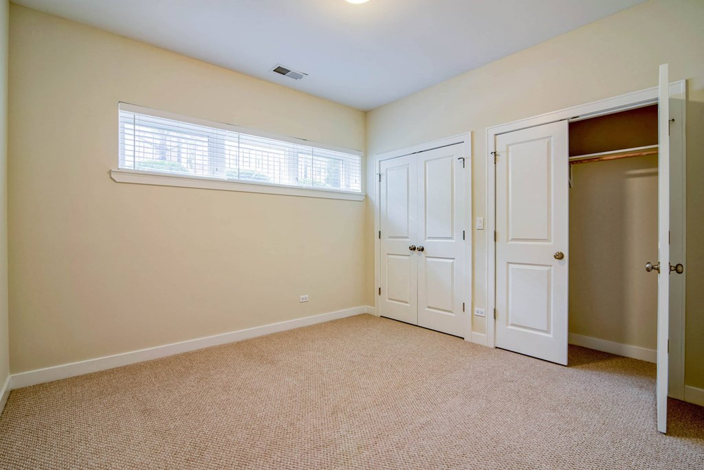 a bedroom with a closet and a window and a door at Montrose 3634, Chicago, IL 60618