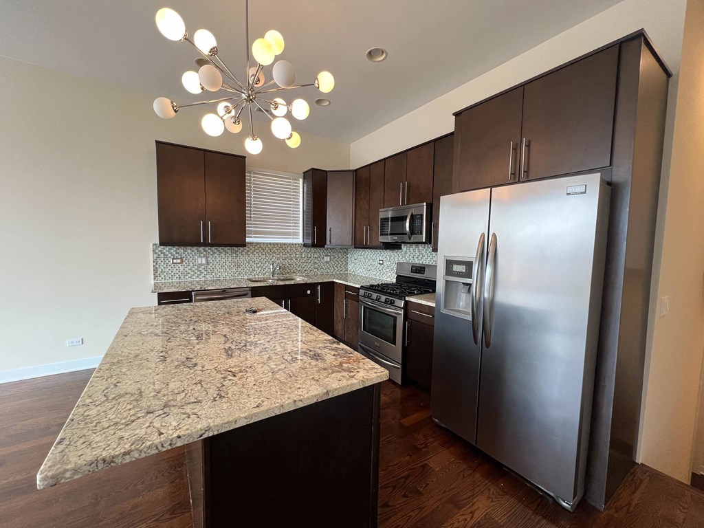 a kitchen with stainless steel appliances and granite counter tops at Montrose 3634, Chicago, 60618