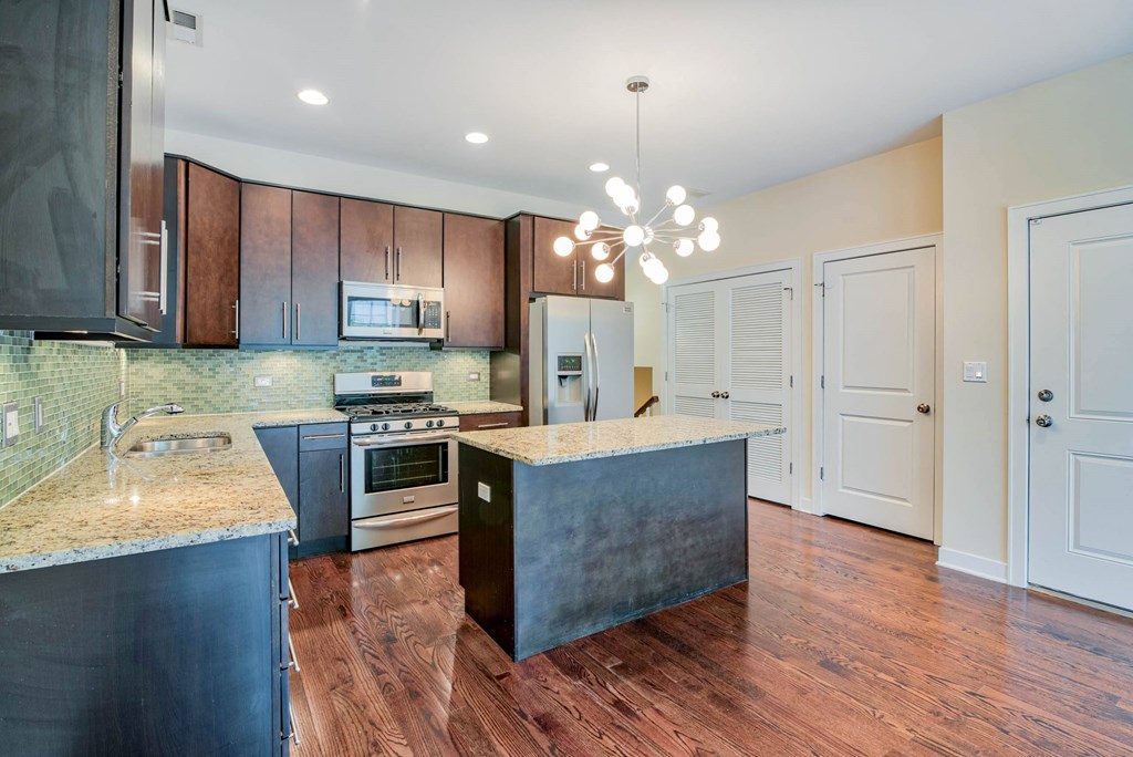 a kitchen with stainless steel appliances and marble counter tops at Montrose 3634, Chicago Illinois