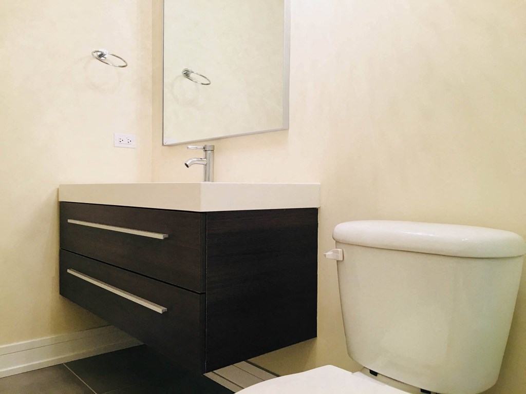 a small bathroom with a toilet and a sink at Montrose 3634, Chicago, 60618