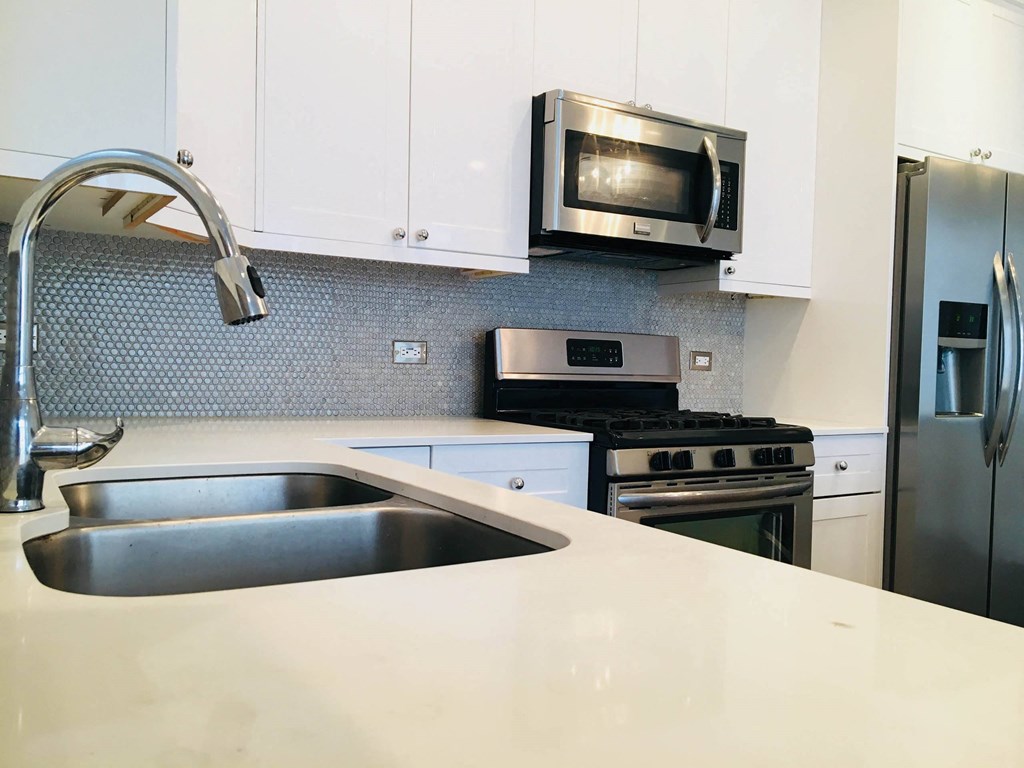 a kitchen with stainless steel appliances and a sink at Montrose 3634, Chicago