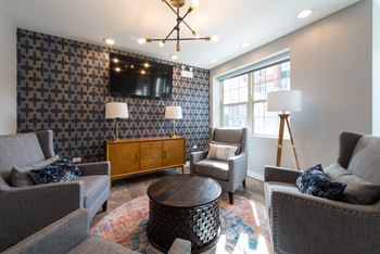 a living room with couches and chairs and a tv