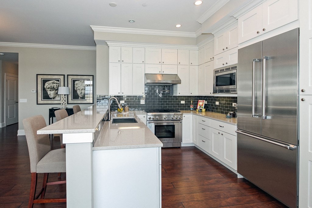 a large kitchen with stainless steel appliances and white cabinets  at Countryside 10765, Illinois