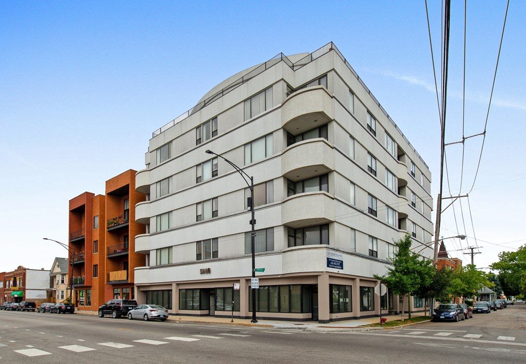 a large white building on the corner of a street
