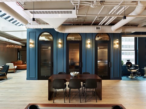 A dining room with a table set for four.