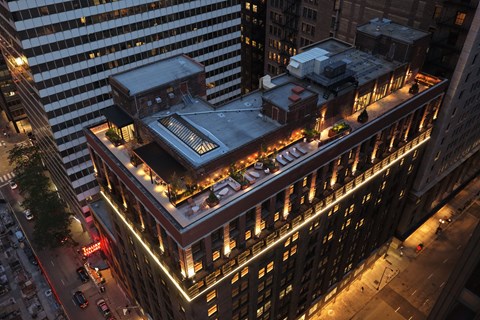 A large building with a lot of windows is lit up at night.
