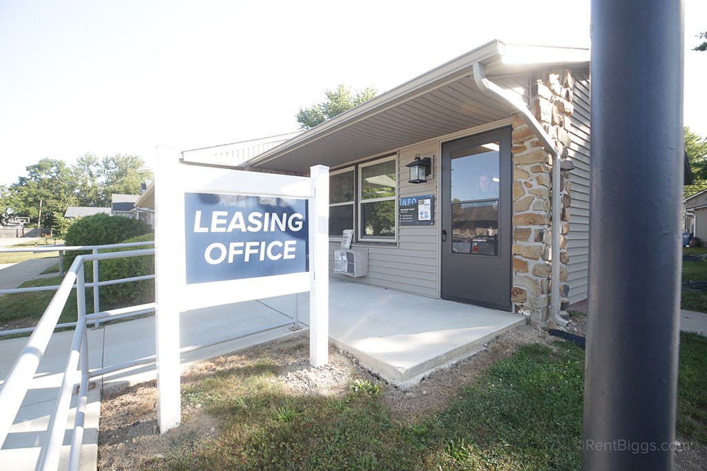 Leasing Office A leasing office is located in a small building with a stone wall.