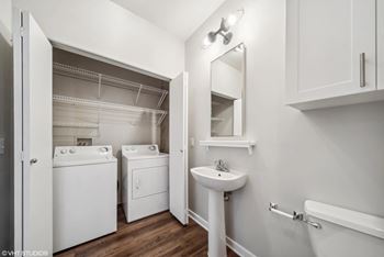 a laundry room with a sink and a washer and dryer and a white