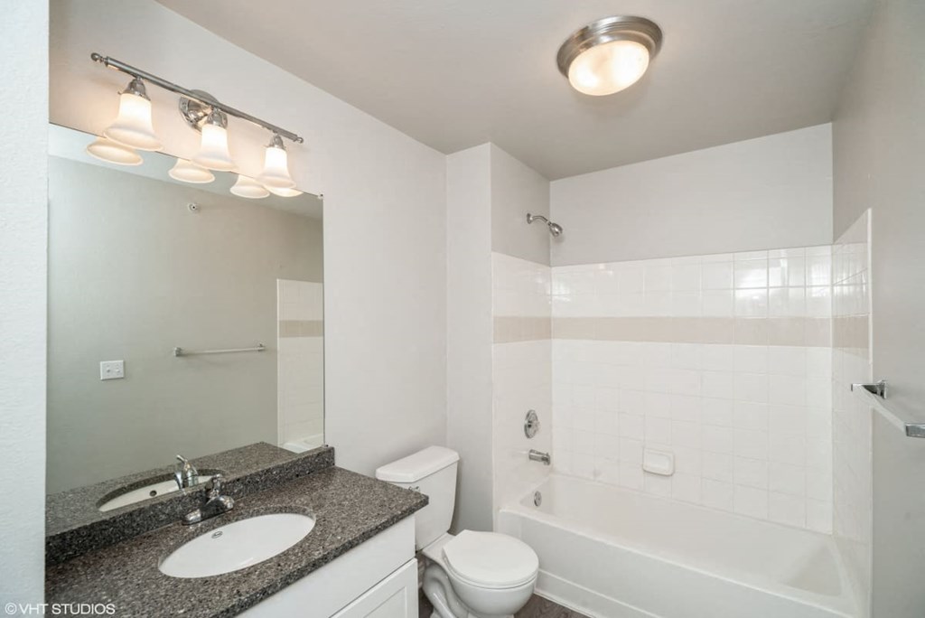 a bathroom with a sink toilet and a bath tub