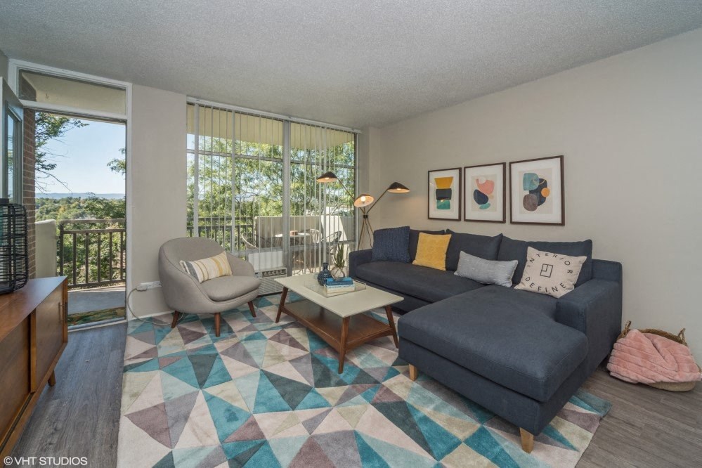 Spacious living room with natural lighting and balcony access Spacious living room with natural lighting and balcony access