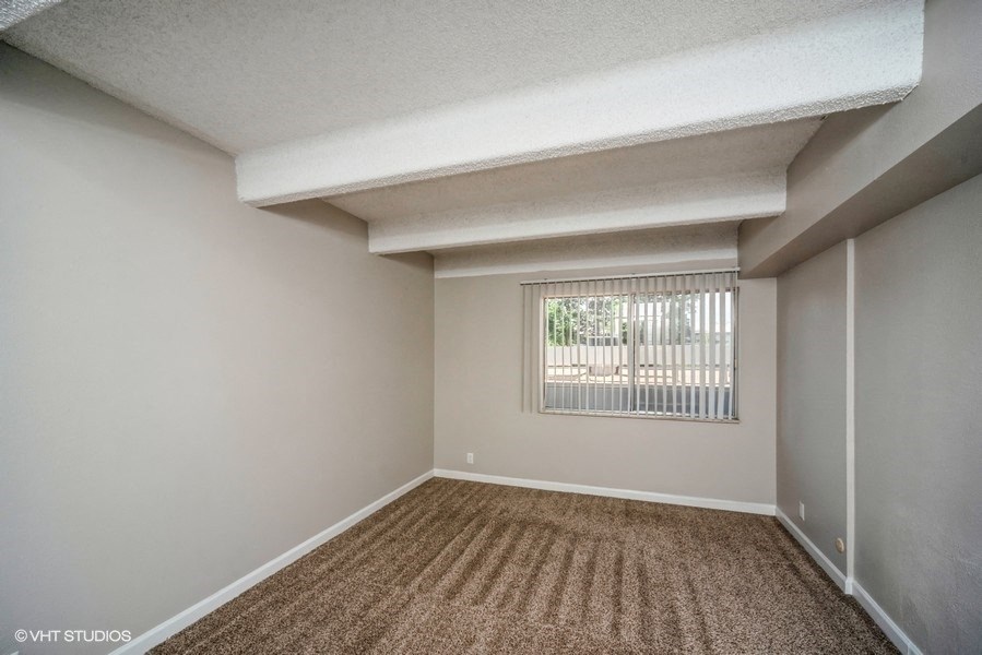 Bedroom with plush carpeting at 878 S Dexter St in Denver, CO