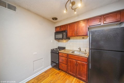 a kitchen with black appliances and wooden cabinets
