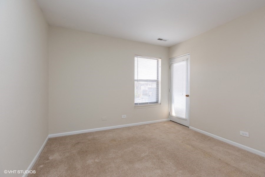 Bright bedroom with plush carpeting