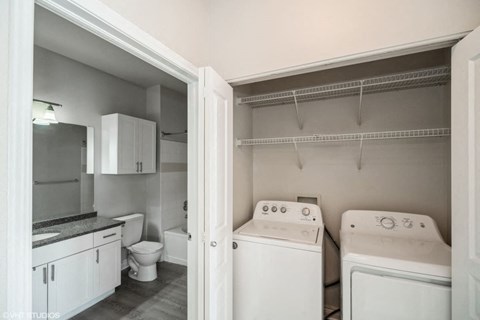 a white kitchen with white appliances and white cabinets