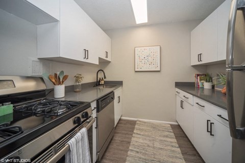 a kitchen with stainless steel appliances and white cabinets