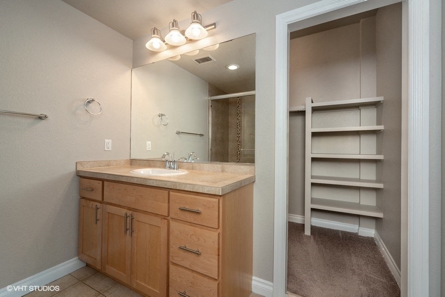 Bathroom with vanity storage and a huge closet