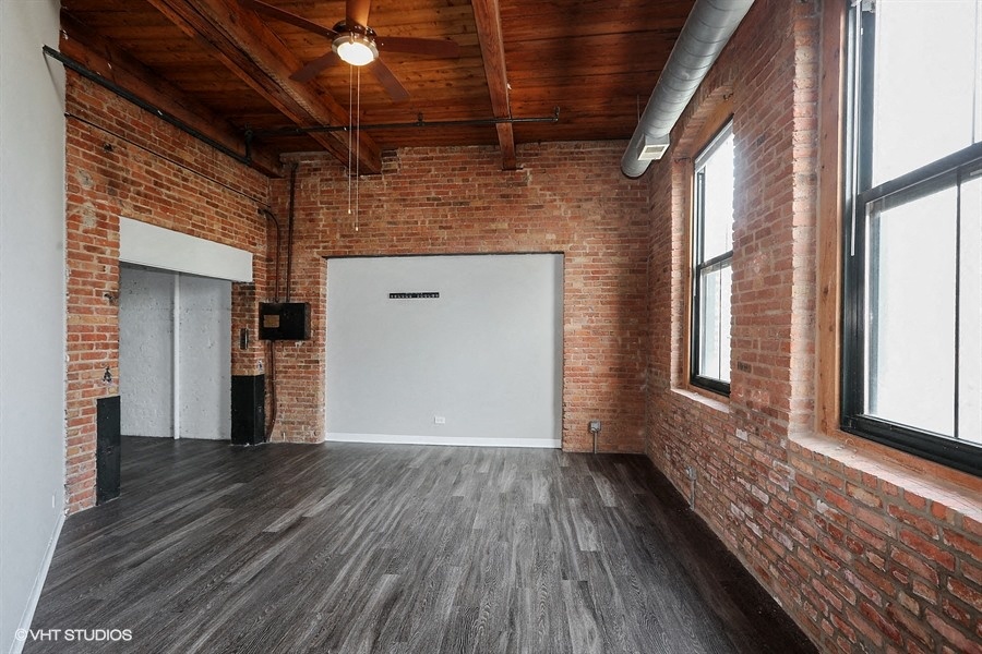 Spacious living area with stunning brick wallsriors- at Carriage House Lofts, Illinois, 60605