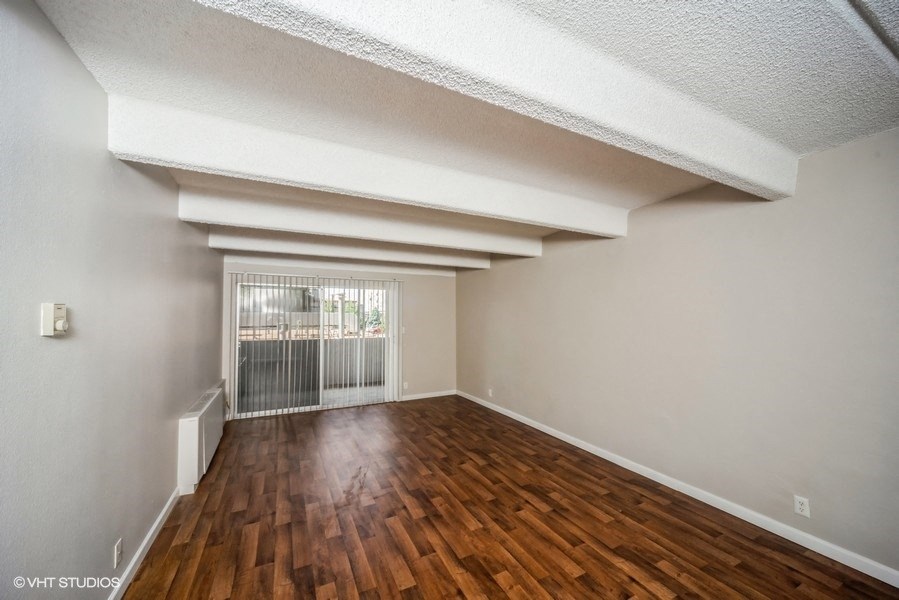 Open and airy living area with chic wood-like flooring at 878 S Dexter St in Denver, CO