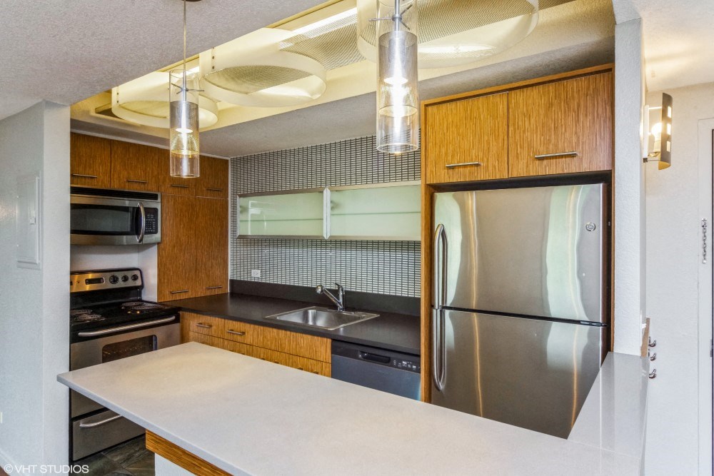 Kitchen with stainless steel appliances and a breakfast bar