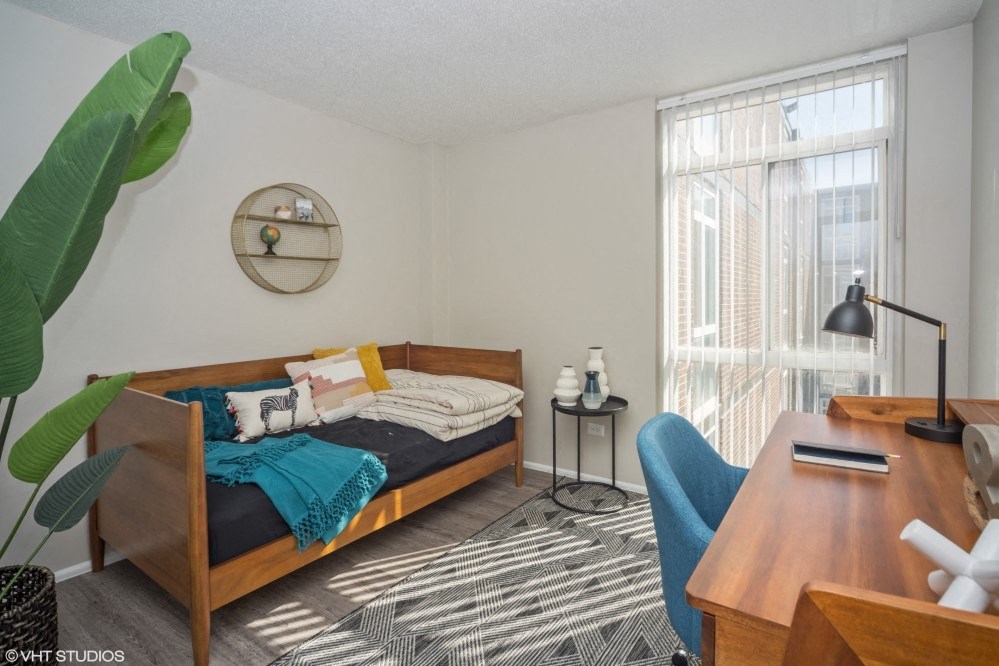 Spacious second bedroom with floor to ceiling window