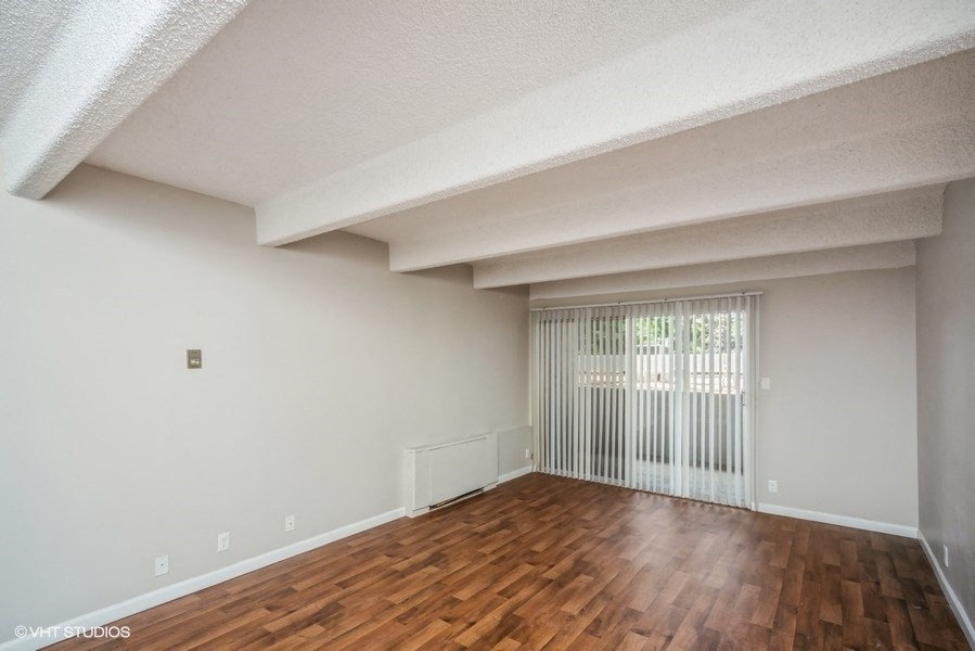 Spacious living room with private patio/balcony access at 878 S Dexter St in Denver, CO
