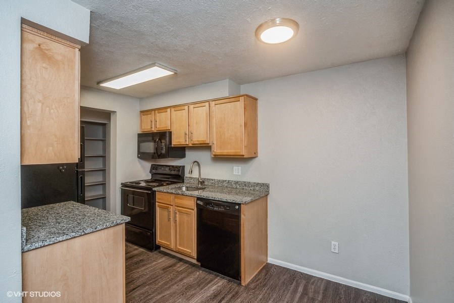 Honey oak colored cabinets and a dishwasher