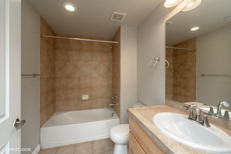 Bathroom with a full tub and vanity storage