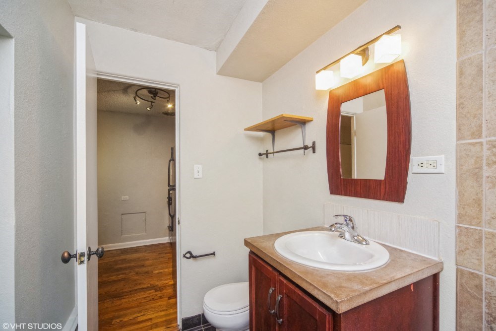 Bathroom with vanity storage and a mirror at 1355 Pearl in Denver, CO