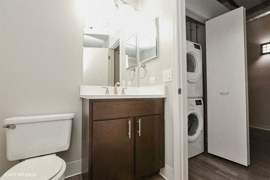 Bright bathrooms space with a stackable washer and dryerat Carriage House Lofts, Chicago, Illinois