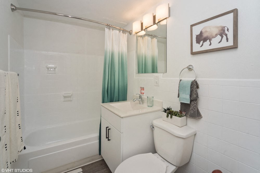 Bright bathroom with tub and vanity storage