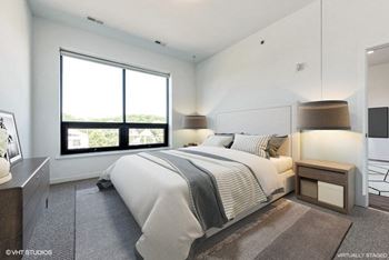 Spacious bedroom with oversized windows and ample natural light. A perfect retreat after a busy day