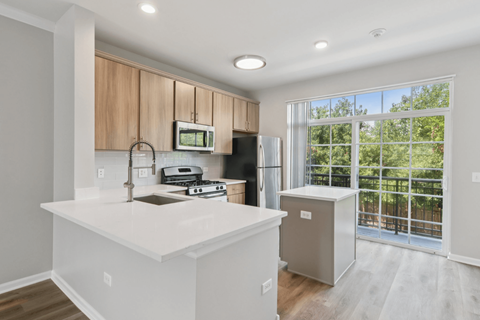 A kitchen with a white countertop and a refrigerator.