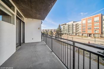 a balcony with a view of a building and a street