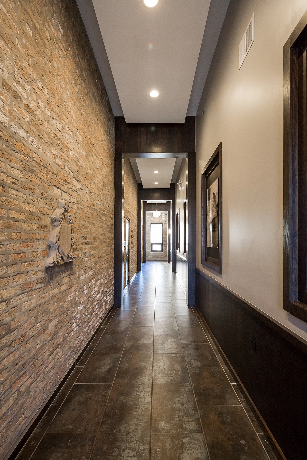 Hallway with exposed brick at Broadway Place