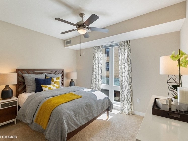 Large Bedroom with a Ceiling Fan and Overhead Lighting