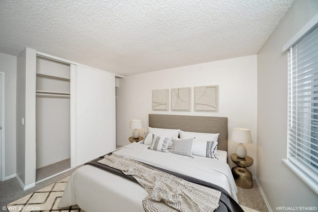 Bedroom with a large bed and a window  at Avery Park in Englewood, CO