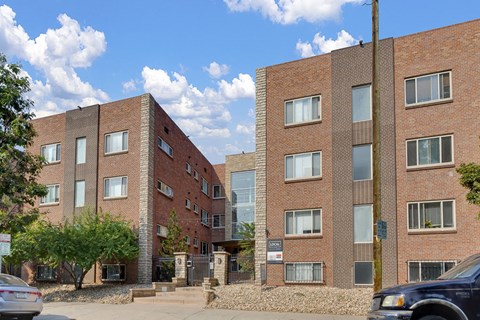Come home to 1335 E Pearl, the exterior of the property is featured here with tall modern buildings at 1355 Pearl in Denver, CO