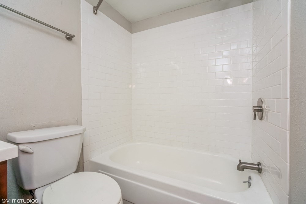 Bright bathroom with tiled tub surround