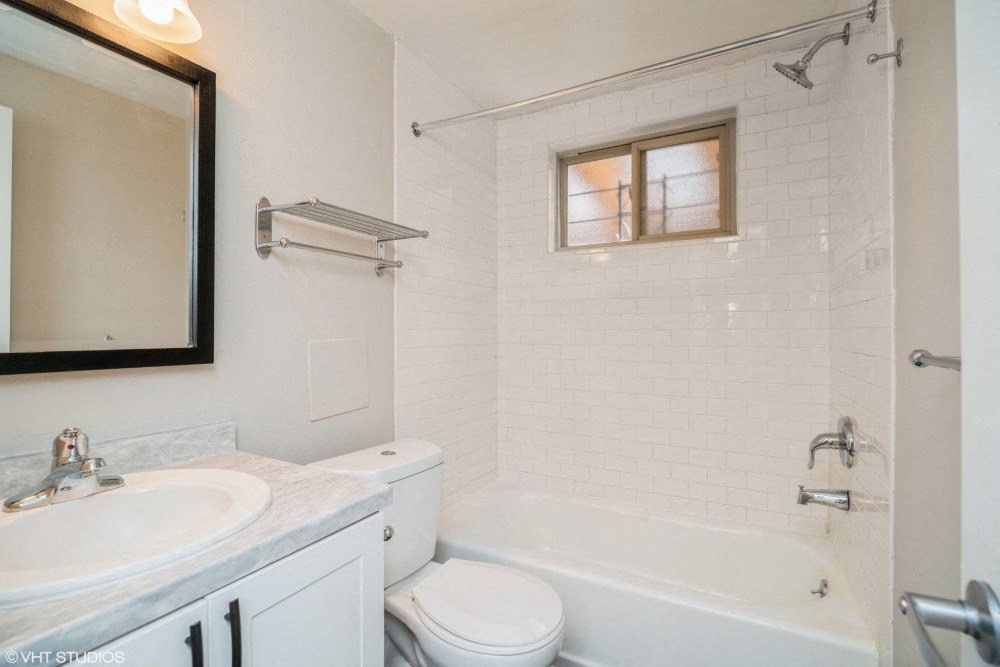 Sparkling White Bathroom with Updated Cabinets at 1443 Elizabeth