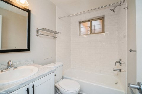 Sparkling White Bathroom with Updated Cabinets at 1443 Elizabeth